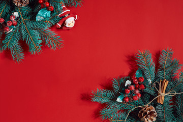 Fir branches border on red background, good for christmas backdrop