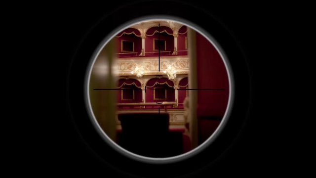 A sniper scope pointing at the interior of an empty theater, peek view from the lodge.
