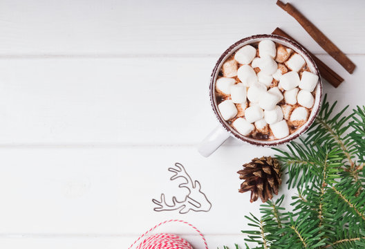 Hot cocoa with marshmallows in the cup on the white background