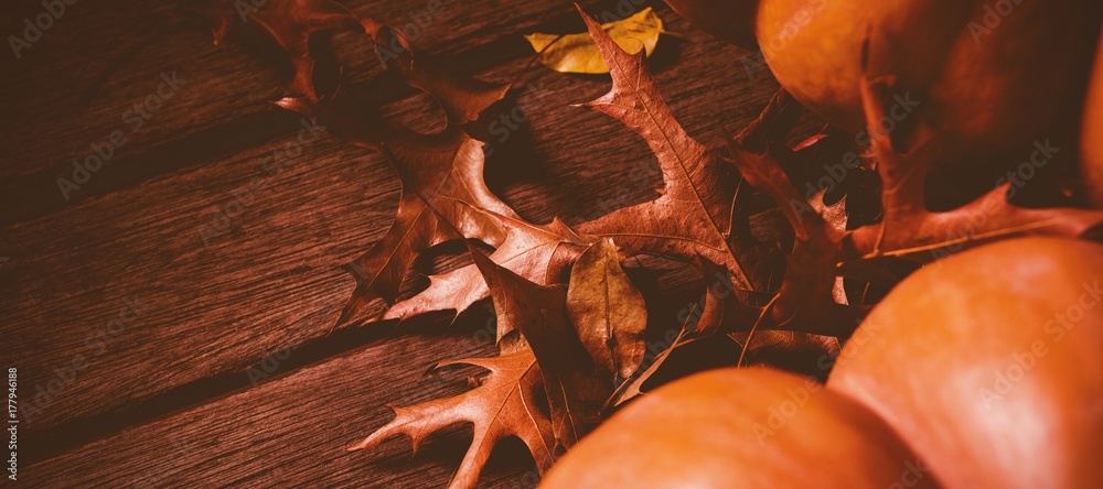 Canvas Prints Pumpkin with autumn leaves on wooden table