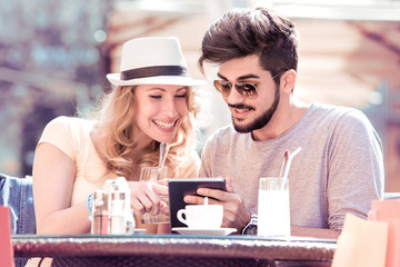 Young couple having good time in restaurant.