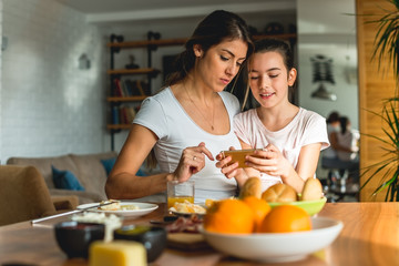 Mother and daughter looking at mobile phone