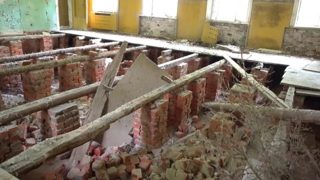 Chernobyl, Ukraine - 17th of June 2017: Visit to Zalesye village in Chernobyl zone - 4K Collapsed floor in the building of cultural center