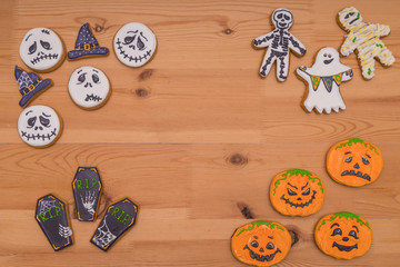 Cookies of different kinds for Halloween on a wooden table. Preparing for Halloween.
