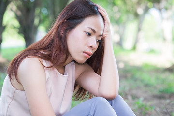 Young woman feel sadness with nature background. Asia woman.