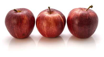 Three whole Gala apples in row isolated on white background