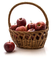 Gala apples in a wicker basket isolated on white background