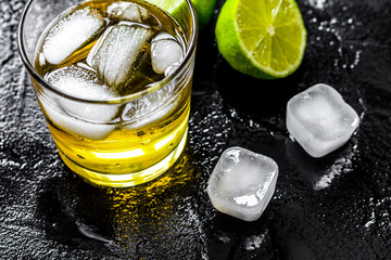 glass of whiskey on dark background