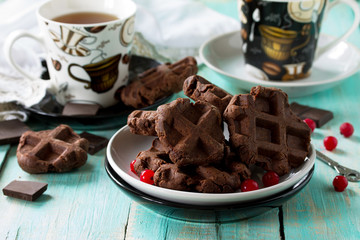 Belgian chocolate wafers with fresh berries and mint on the kitchen wooden table, home healthy breakfast.
