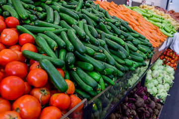 Close up Fresh vegetables at the counter of the vegetable shop, farmer marketplace. Organic, healthy, vegetarian diet food concept. Selective focus