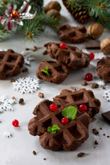 Homemade Belgian chocolate wafers with fresh berries and mint on a gray stone or slate background, Christmas background.