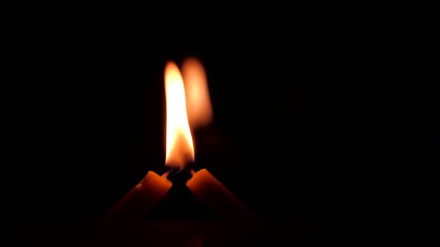 Two candle flame on a black background.