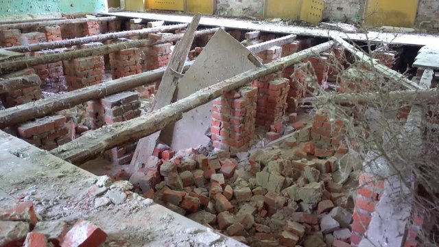 Chernobyl, Ukraine - 17th of June 2017: Visit to Zalesye village in Chernobyl zone - 4K Collapsed floor in the building of cultural center