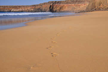 footprints on sand beach