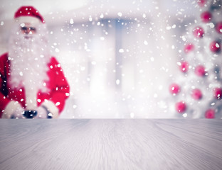 Empty table in front of blurred Santa Claus and Christmas tree. Vintage filter