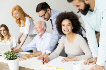 Joyful multiracial business team at work in modern office