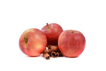three apples and cinnamon sticks isolated on white background