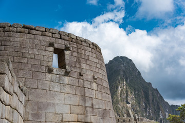 Fototapeta na wymiar Stone built structure on Machu Picchu with Huayna Picchu in the background.