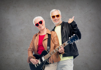 Fototapeta na wymiar happy senior couple with guitar showing thumbs up