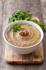 Lentil hummus in bowl on wood