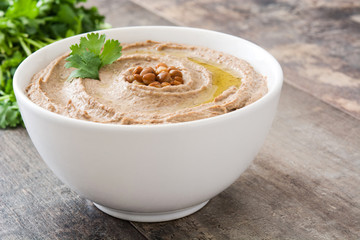 Lentil hummus in bowl on wood