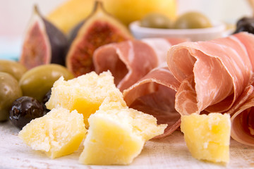  Slices of prosciutto, pieces of cheese, olives and figs