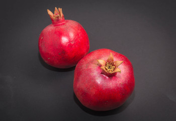 Fresh pomegranate macro picture on isolated black background