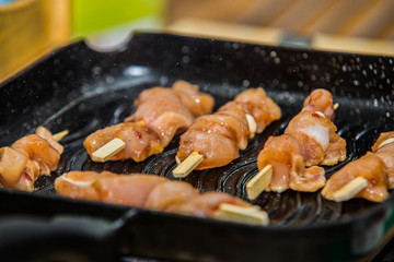 fresh sticks with meat cooked on grill.