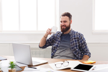Fototapeta premium Happy businessman with laptop in modern white office