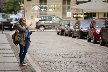 Augmented reality in marketing. Woman traveler with phone. Navigation on the projection of the...