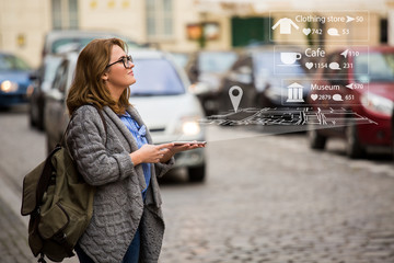 Augmented reality in marketing. Woman traveler with phone. Navigation on the projection of the...