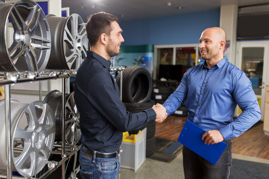 auto business owner and wheel rims at car service