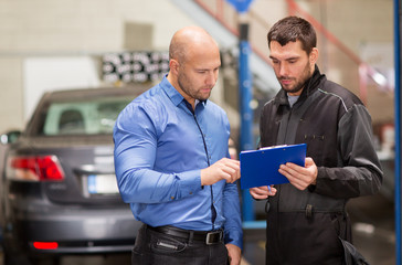 auto mechanic and customer at car shop