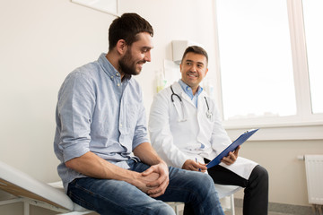 smiling doctor and young man meeting at hospital - Powered by Adobe