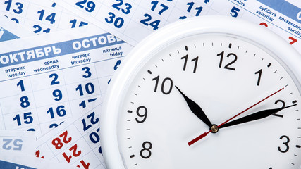 Fototapeta premium clock with wall calendar sheets with the number of days