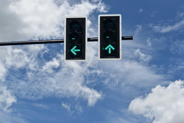 Ant view the traffic light turn green on background with a bright sky.