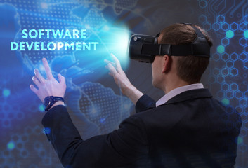 Business, Technology, Internet and network concept. Young businessman working in virtual reality glasses sees the inscription: Software development