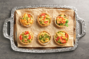 Delicious crispy tarts with broccoli on metal tray