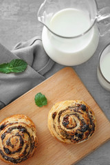 Tasty pastry with poppy seeds on wooden board