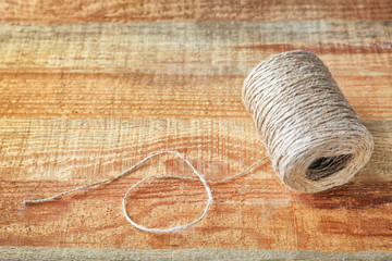 Hank of hemp twine on wooden background