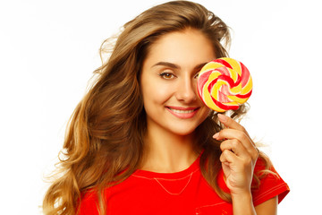 Portrait of a happy pretty girl holding sweet candy over white background