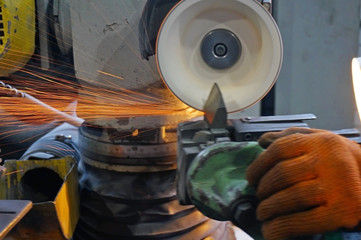 metalworking industry: finishing metal working on horizontal surface grinder machine with flying sparks