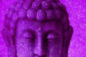 Photograph of a Buddha figure with the pink background
