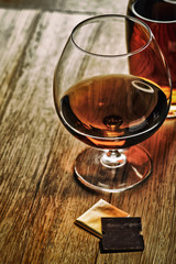 Glass of brandy or cognac on the wooden table.