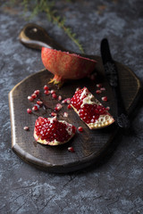 Red juice pomegranate on dark background