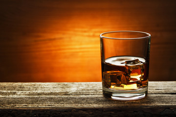 whiskey with ice on a wooden table