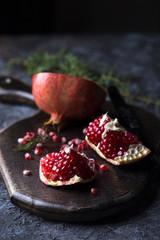 Red juice pomegranate on dark background