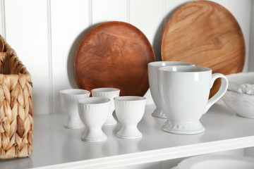 White storage stand with dishware in kitchen