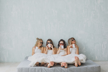Crazy party time of four beautiful stylish women. group of beautiful young woman napping in her bed...