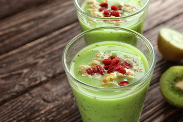 Smoothie with goji berries in glass on table